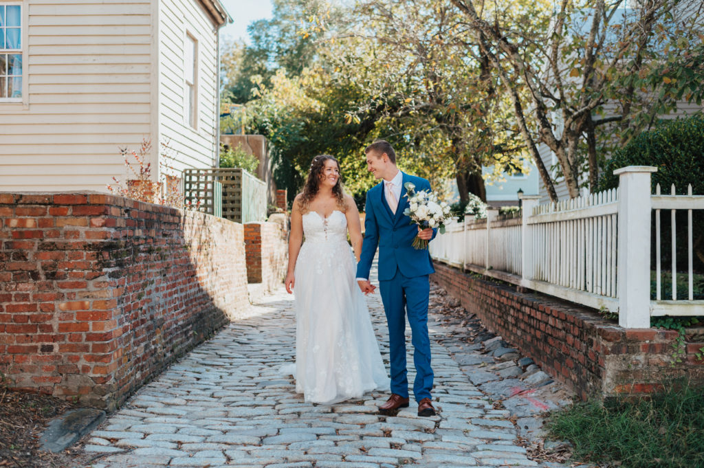 bride and groom walking in wedding attire