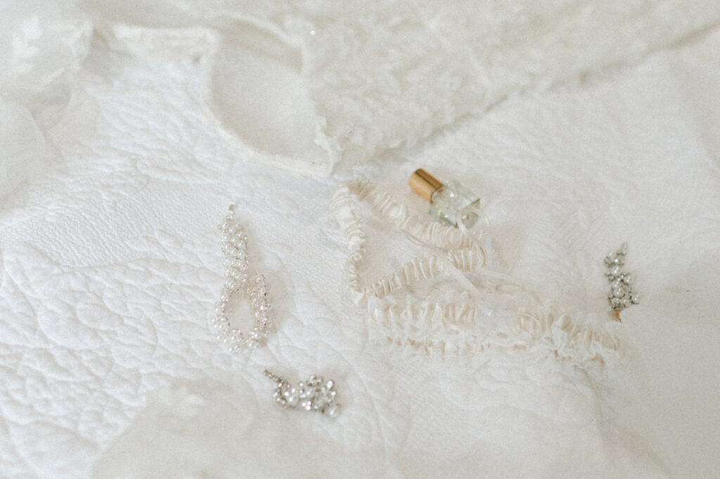 Bridal details, garter, perfume and dress