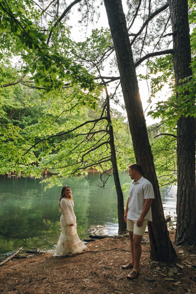 Oahu engagement session in front of lake surrounded by greenery