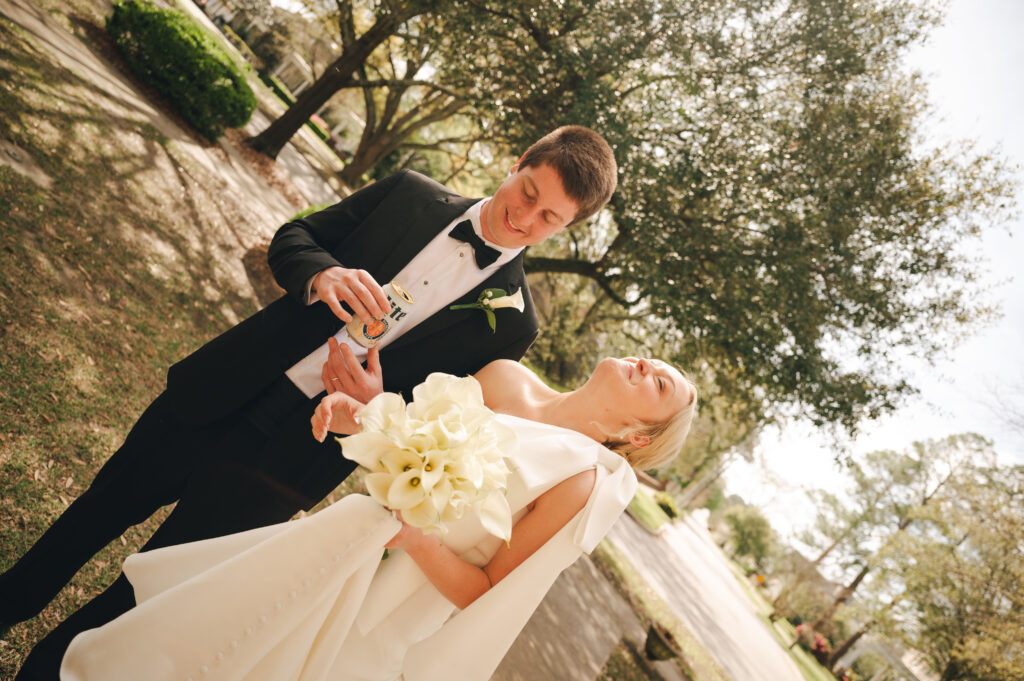 Married couple laughing and drinking a beer after their ceremony