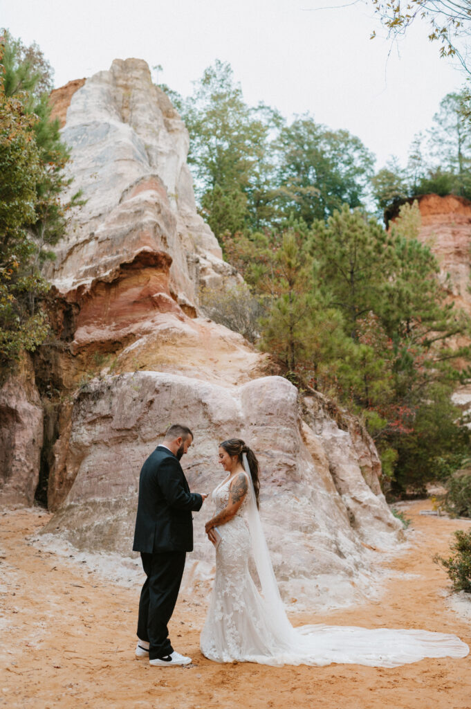 Elopement in Kauai Hawaii with the couple saying their vows in front of the red red rocks