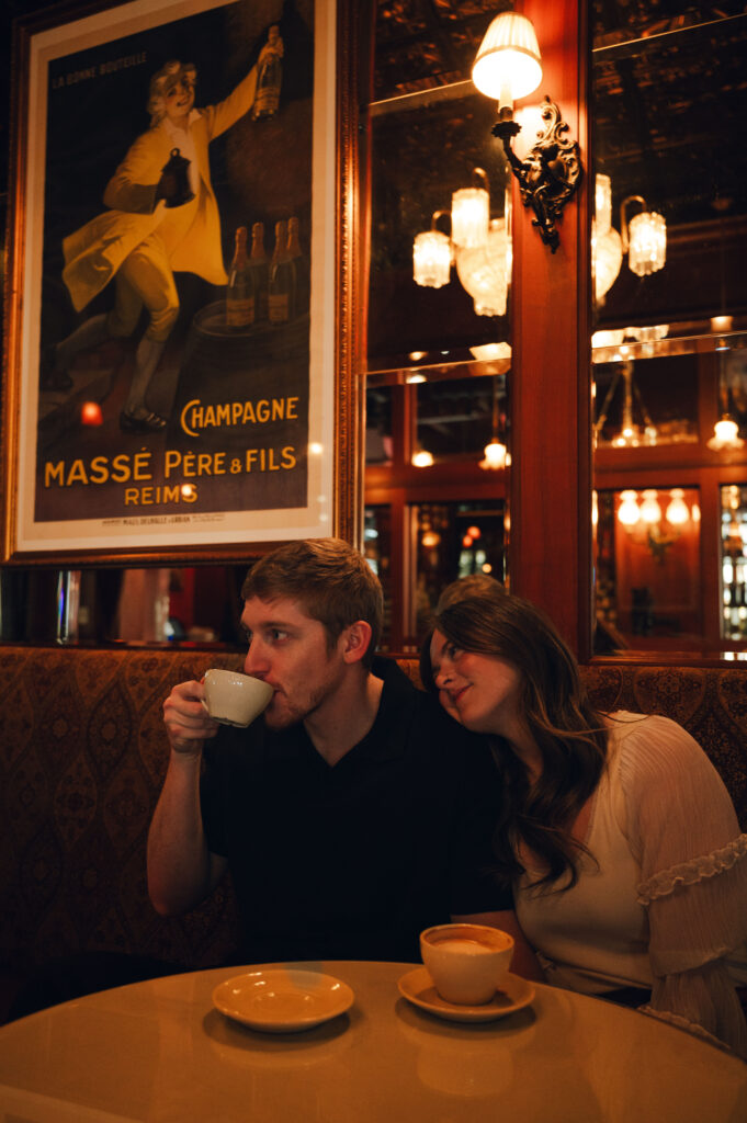 couple cozied up together drinking coffee together for an engagement session