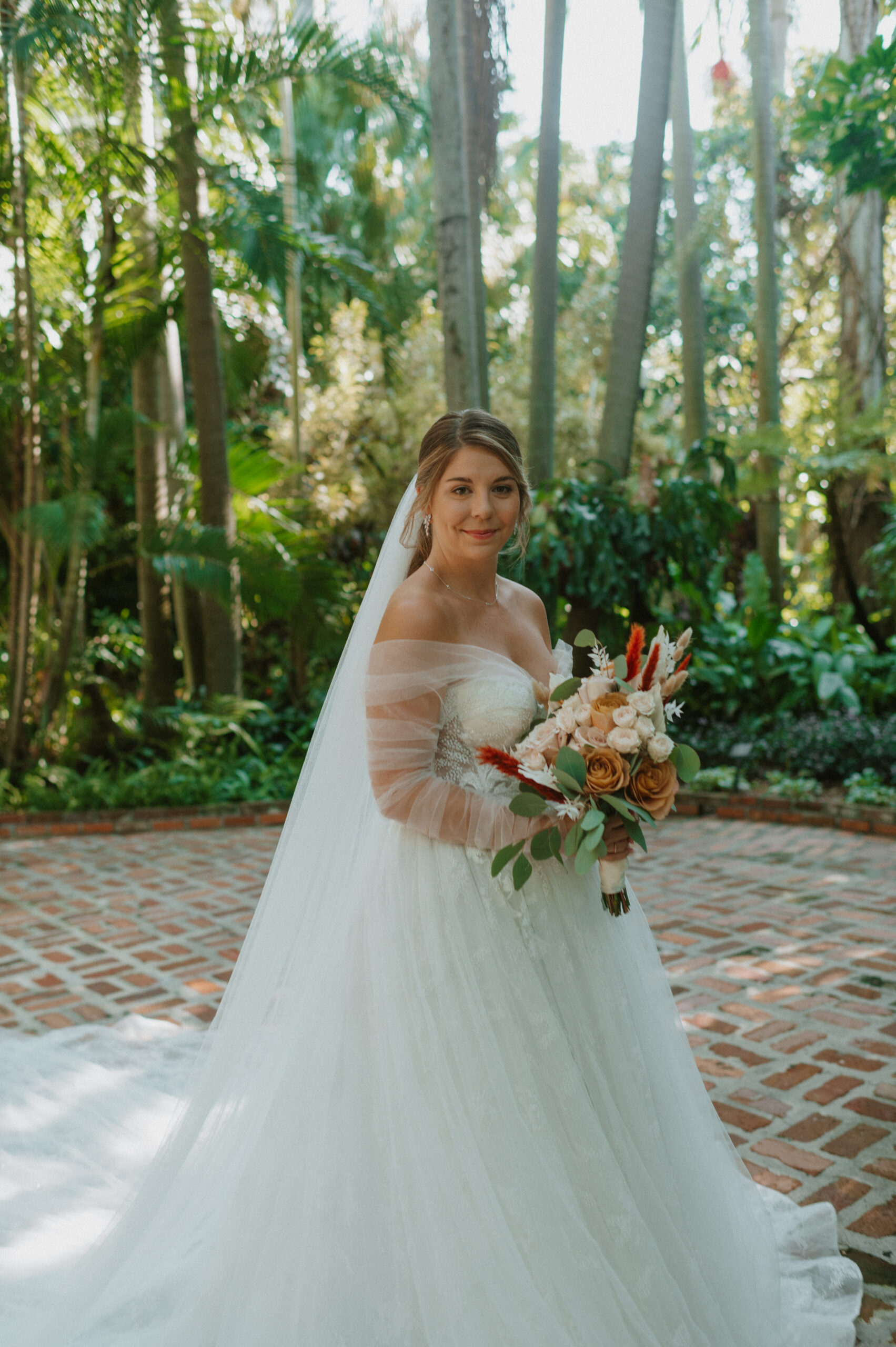 Bride standing with Bouquet in Hawaii rain forest