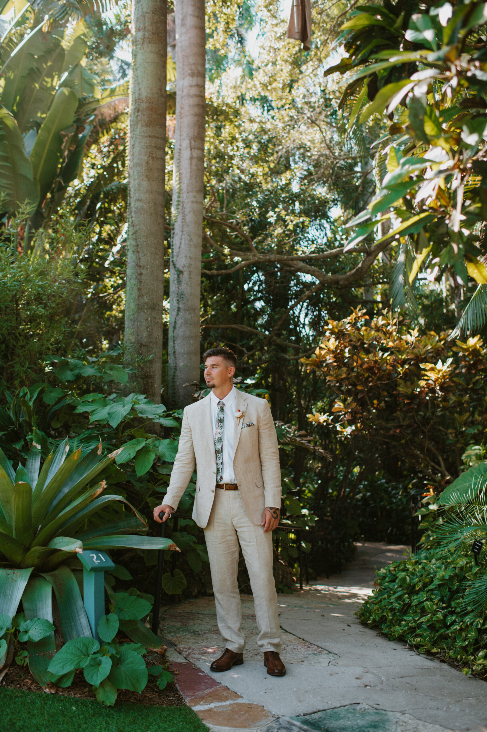 Groom standing in the forest of Hawaii posing before getting married