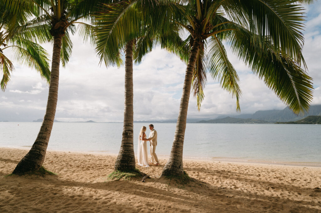 Couple getting married on the beach at Kauloa Ranch beach 