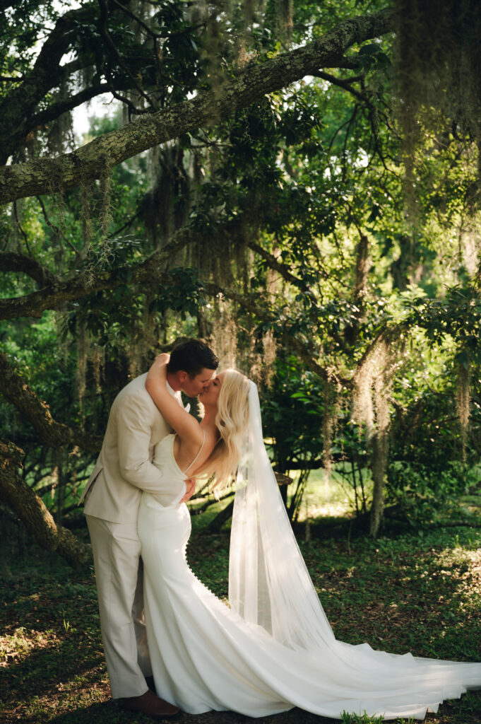 Bride and Groom kissing in the forest in Hawaii