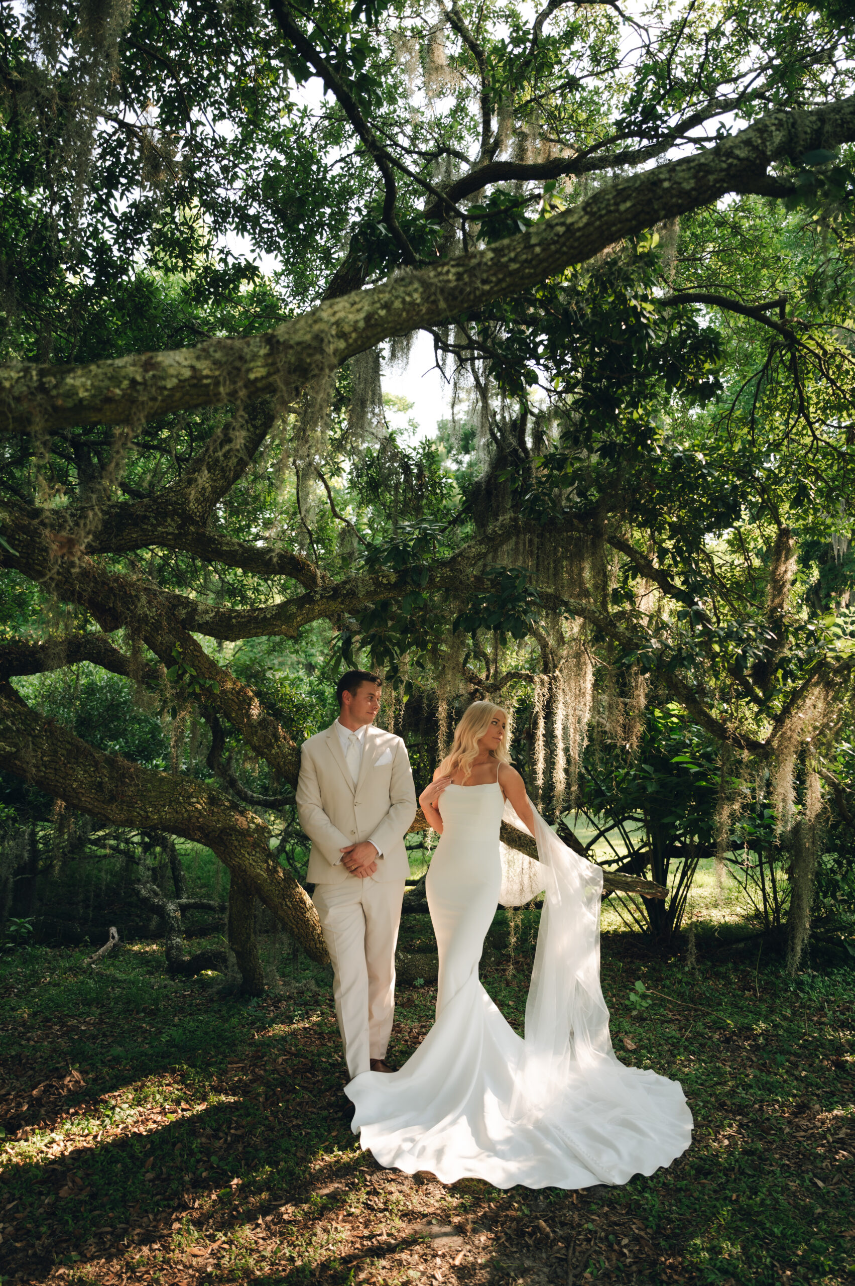 married couple getting married in Hawaii under the lush greenery 